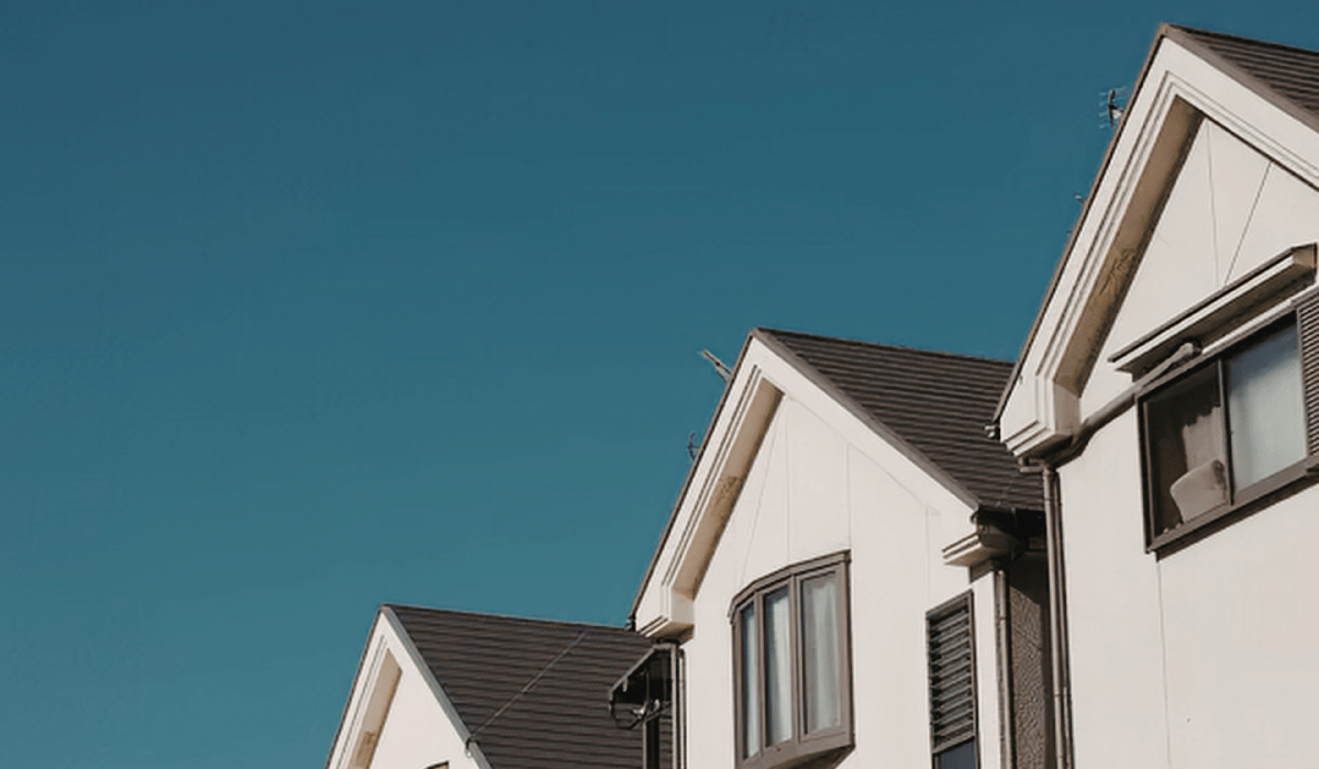 professional painter applying masonry paint to rendered wall